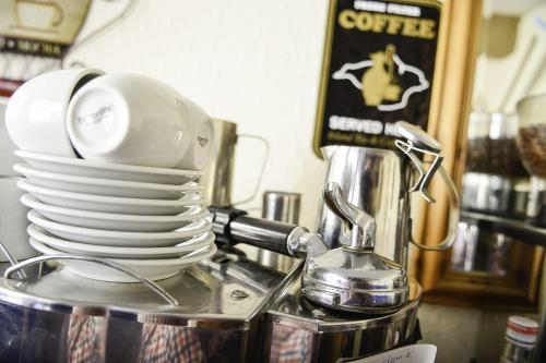a stack of plates sitting on top of a blender at Waverley Inn in Newport