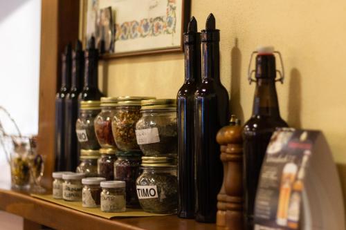 a shelf with jars of pickles on it at Albergo Santo Spirito in Molini di Triora