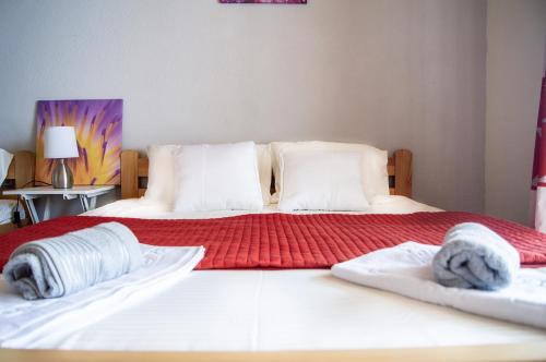 a bedroom with two beds with towels on them at Villa Lakeview Paradise in Peštani