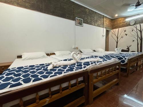 two twin beds in a room at Greenwoods Nature Camp in Mudumalai National Park