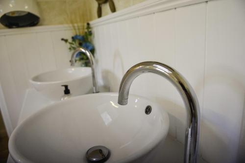 a white sink in a bathroom with aaucet at Waverley Inn in Newport