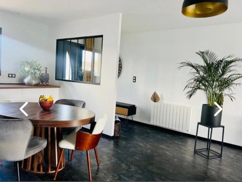 ein Esszimmer mit einem Tisch und Stühlen in der Unterkunft Maison de vacances in Tonnay-Charente