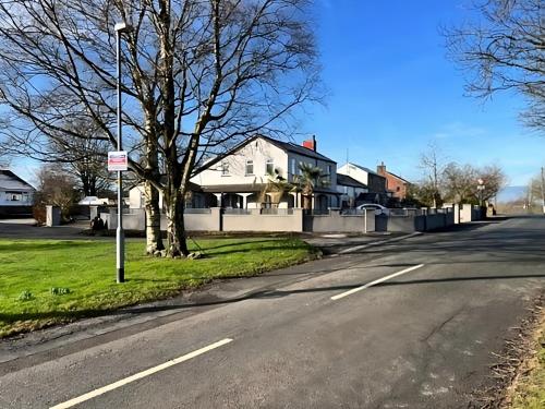 an empty street in a residential neighborhood with houses at Spacious 2 Bed Ribble Valley Apartment in Blackburn
