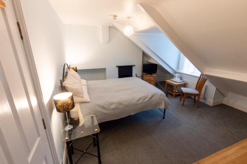 a bedroom with a bed in a attic at Big Sky Guest House- ROOM ONLY in Whitby