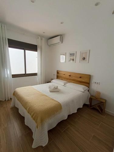 a bedroom with a large bed with a wooden headboard at Casita El Lagar in Estepona