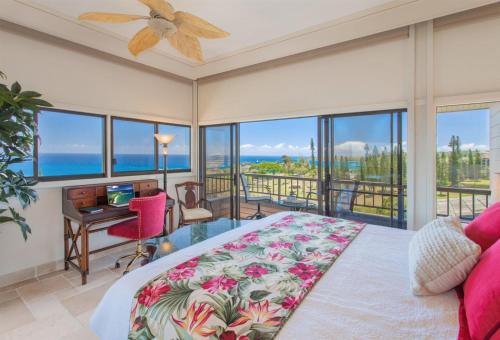 a bedroom with a bed and a view of the ocean at 622 Kapalua Ridge Villa in Kahana