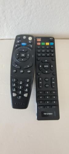two remote controls sitting next to each other on a table at Greystone Guesthouse in Jeffreys Bay