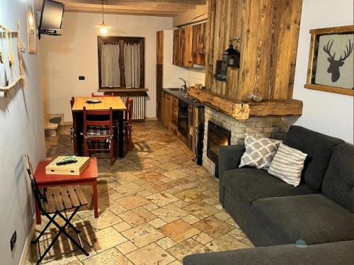 a living room with a couch and a fireplace at Chalet Beatrice in Ledro