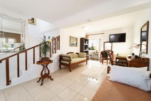 a living room with a staircase and a living room at LA SAN PEDRO I Laganas Karydakis in Laganas