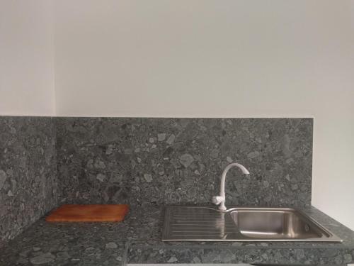 a kitchen sink with a faucet on a counter at Coastal Cloud in Hikkaduwa