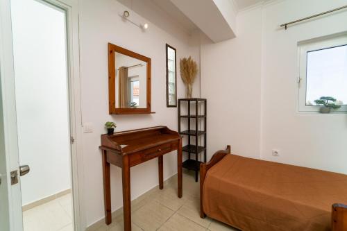 a bedroom with a bed and a desk and a mirror at PEDRO NAVARINO ΙΙΙ Laganas in Laganas
