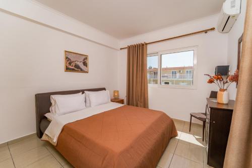 a hotel room with a bed and a window at PEDRO NAVARINO ΙΙΙ Laganas in Laganas