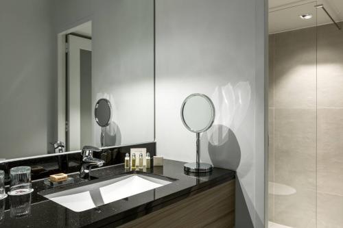 a bathroom with a sink and a mirror at Amsterdam Marriott Hotel in Amsterdam