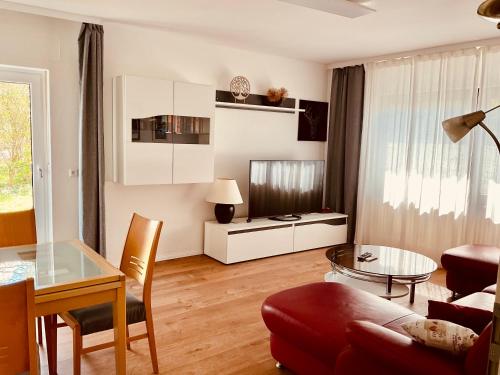 a living room with a couch and a table at Ferienwohnung Raevenhof in Ayl