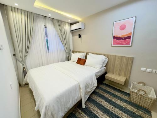 a hotel room with two beds and a window at Swanky apartment in Douala