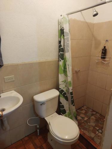 y baño con aseo y lavamanos. en Cómodo apartamento, en Amatitlán