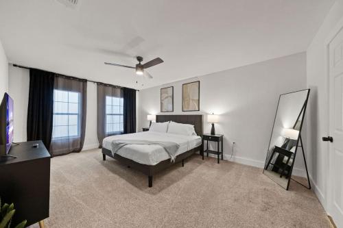 a bedroom with a bed and a television in it at Spacious 6 Bed House near Airport, Pet-Friendly, Close to AFB in San Antonio