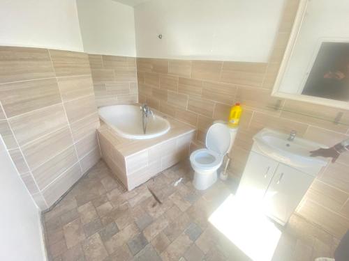 a bathroom with a toilet and a tub and a sink at Pacific hotel in Clacton-on-Sea