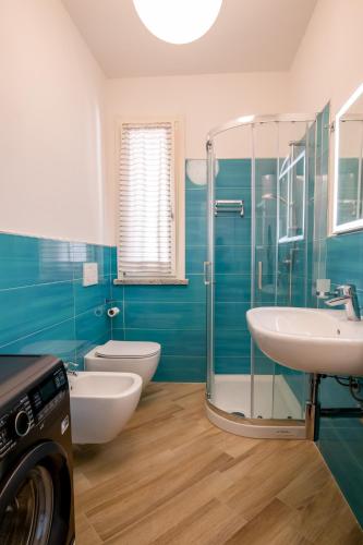 a bathroom with two toilets and a sink and a shower at Casa Sestini in Capoliveri