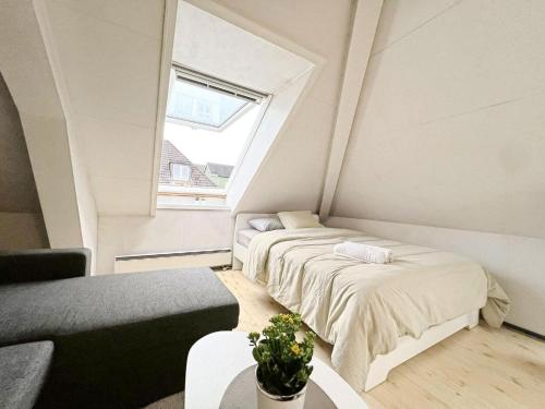 a small bedroom with two beds and a window at City View & Central Location in Trondheim