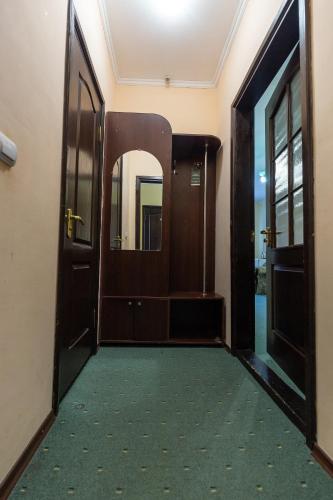 an open door to a room with a green carpet at Алексік in Truskavets