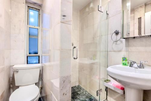 a bathroom with a toilet and a sink at Stylish and Cozy 2BD apartment in New York