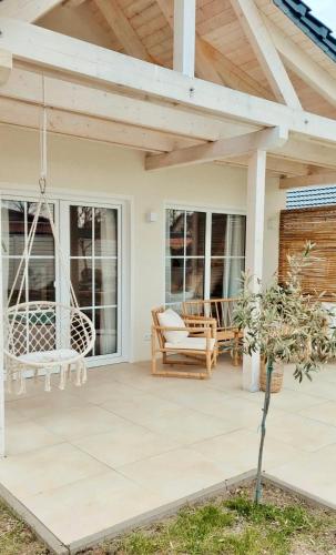 a patio with a wooden pergola and swings at Mabé in Lauta