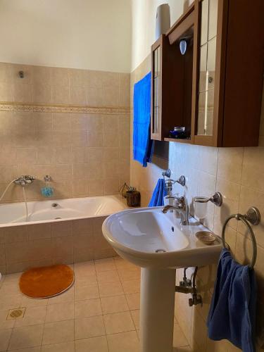 a bathroom with a sink and a bath tub at Evgoro in Chania