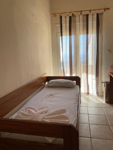a small bed in a room with a window at Evgoro in Chania