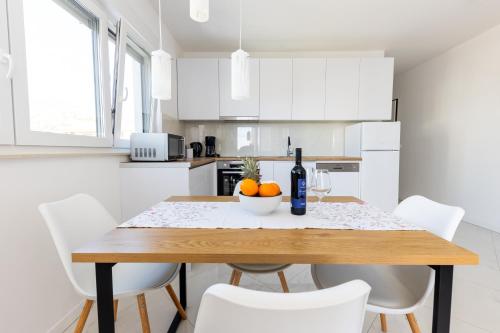 a kitchen with a wooden table with a bowl of oranges at Sore in Trogir