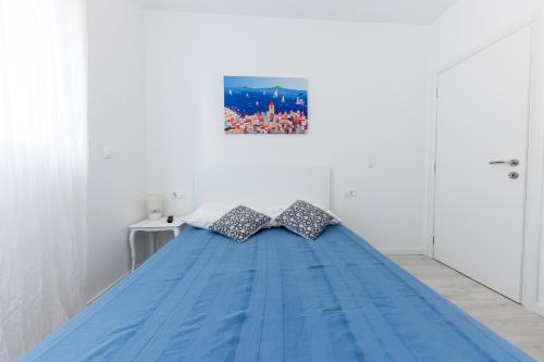 a bed with two pillows on it in a room at Sore in Trogir