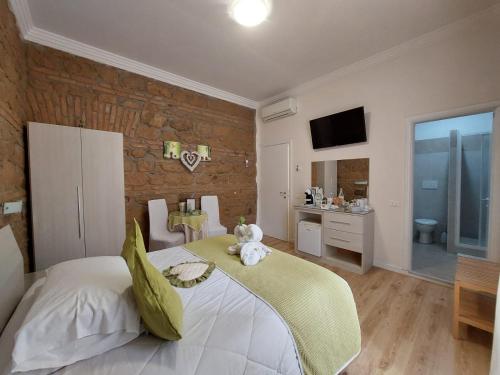 a bedroom with a bed with a teddy bear on it at Freedom Love B&B in Rome