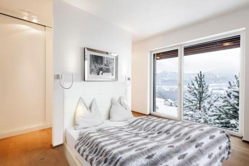 a bedroom with a bed and a large window at Luxus Wohnung mit Panoramablick in Mondsee