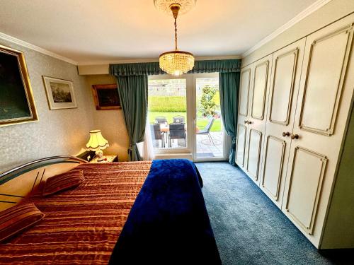 a bedroom with a bed and a door to a patio at Chlösterli in Lucerne