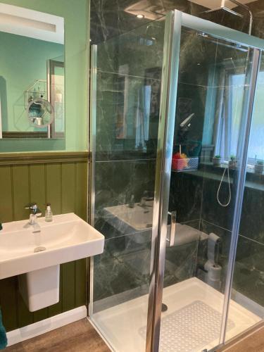 a bathroom with a shower and a sink at Skyefall Self Catering in Uig