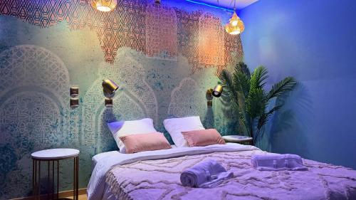 a bedroom with a bed and a wall with a map at Évasion Emeraude in Roubaix