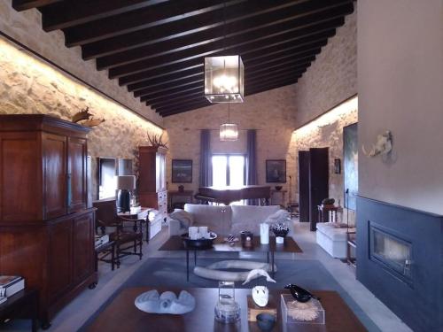 a large living room with a couch and a fireplace at Luxurious secluded villa in Calaceite