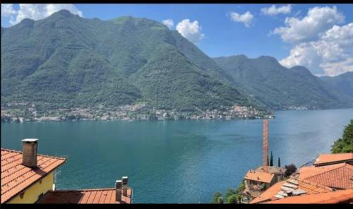 a view of a large body of water with mountains at La corte sul lago in Pognana Lario