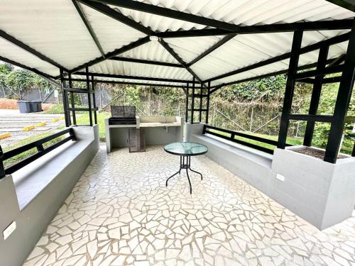 a pavilion with a table and a bench at Apartamento 205 torre C Reserva de la Colina La Tebaida Quindio in La Tebaida