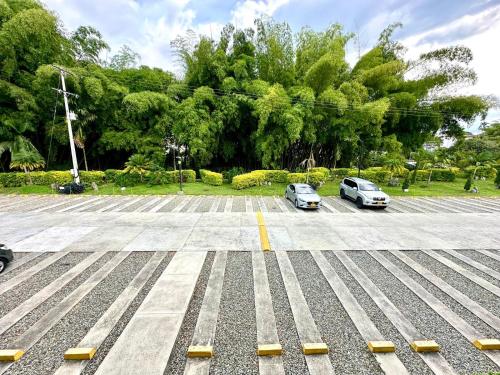 two cars parked in a parking lot with trees at Apartamento 205 torre C Reserva de la Colina La Tebaida Quindio in La Tebaida