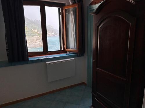 a room with a window with a view of the ocean at Palazzo Vingius in Minori
