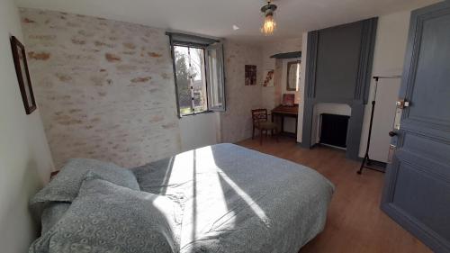 Ένα ή περισσότερα κρεβάτια σε δωμάτιο στο Le Clos des Quatre Lieues