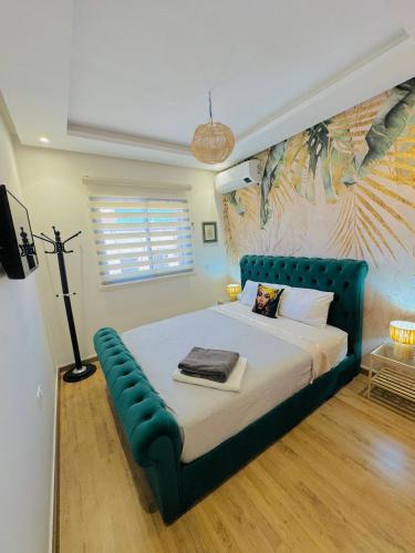 Le Majorelle Cozy Flat في مراكش: غرفة نوم مع سرير مع إطار سرير أزرق