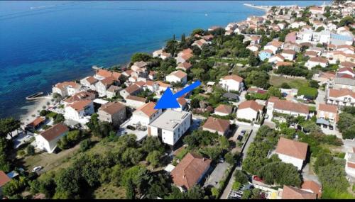a city with a blue arrow on top of it at Apartments Mamma Mia in Orebić