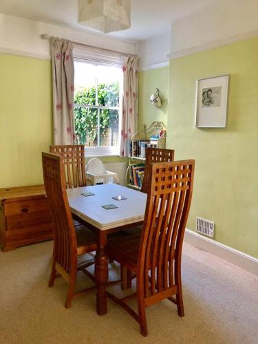 a dining room with a table and four chairs at Welcoming Southwold Holiday Home in Southwold