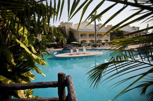 a large swimming pool with a building in the background at Telamar Resort in Tela