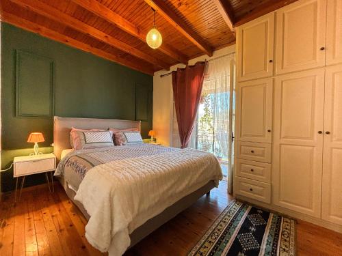 a bedroom with a bed and a large window at Virginia's Penthouse in Kassiopi