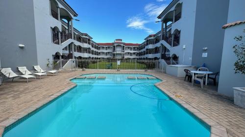 a swimming pool in the middle of a building at Greenpoint Mews 17, Plettenberg Bay in Plettenberg Bay