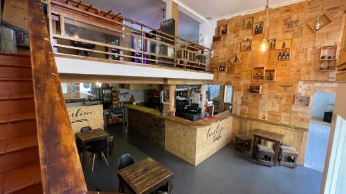 a restaurant with a counter and tables in a room at Lambisco- Alojamento local in Alfândega da Fé