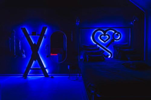 a bedroom with a bed with a heart and a cross at Casa Love - Love Room in Quincy-Voisins